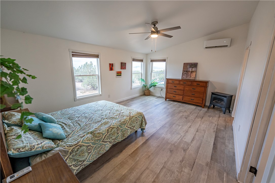 2765 North Silver Springs Road Kingman, AZ 86401 - Photo 31 of 60 a bedroom with a bed chandelier and a window