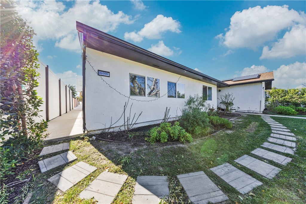 20200 Lassen Street Chatsworth, CA 91311 - Photo 12 of 32 a front view of a house with a yard