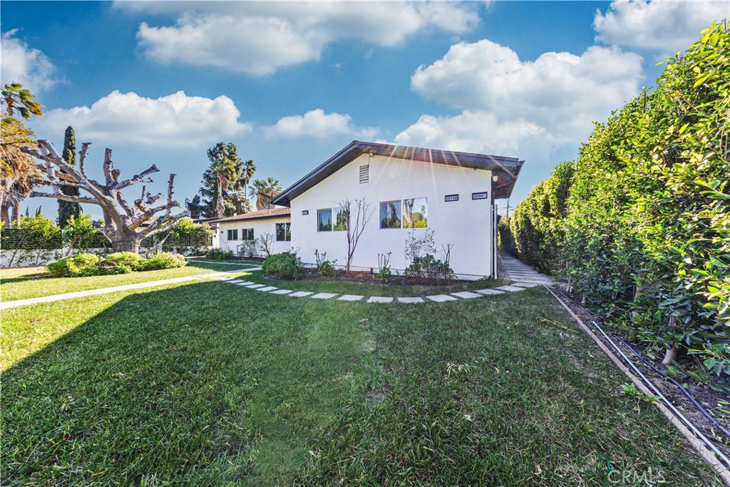 20200 Lassen Street Chatsworth, CA 91311 - Photo 13 of 32 a front view of a house with garden