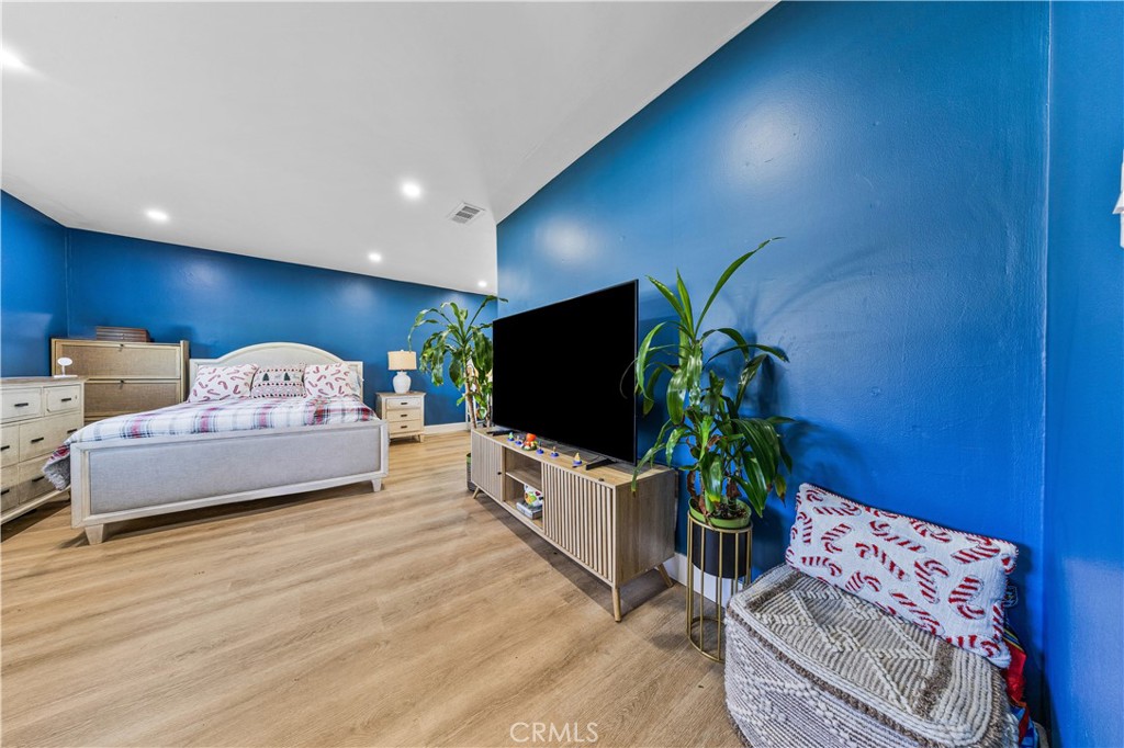 20200 Lassen Street Chatsworth, CA 91311 - Photo 14 of 32 a spacious bedroom with a bed and a flat screen tv