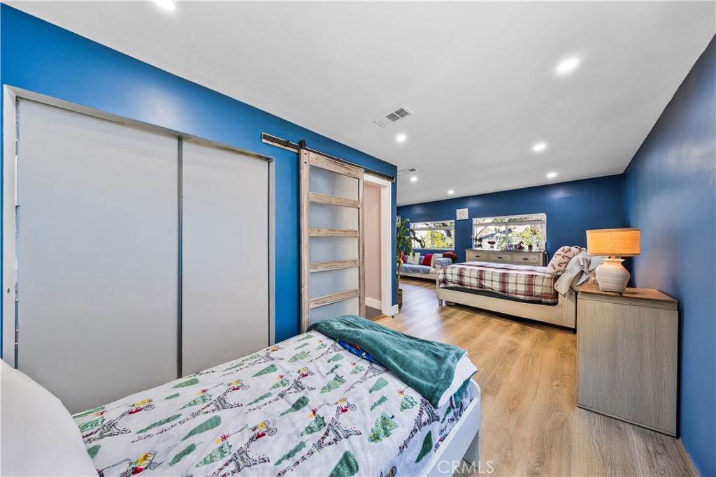 20200 Lassen Street Chatsworth, CA 91311 - Photo 20 of 32 a bedroom with a bed and a dresser in it