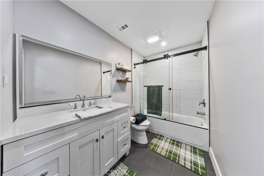 20200 Lassen Street Chatsworth, CA 91311 - Photo 24 of 32 a bathroom with a double vanity sink mirror double and shower