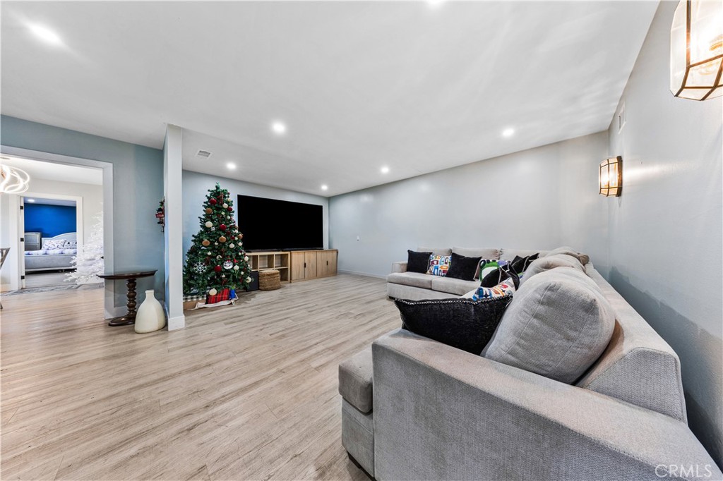 20200 Lassen Street Chatsworth, CA 91311 - Photo 26 of 32 a living room with furniture and a flat screen tv