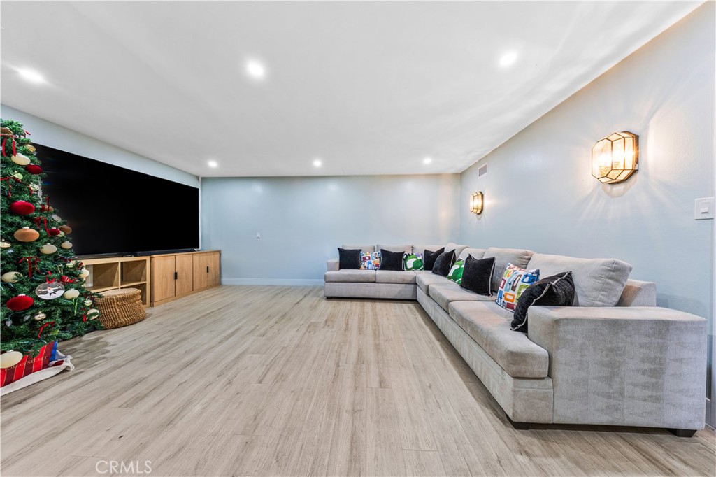 20200 Lassen Street Chatsworth, CA 91311 - Photo 28 of 32 a living room with furniture and a flat screen tv