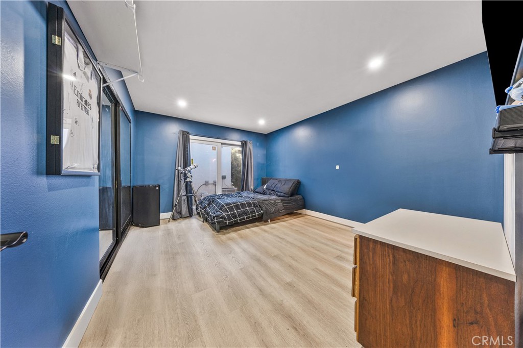 20200 Lassen Street Chatsworth, CA 91311 - Photo 29 of 32 a bedroom with a bed and a large mirror