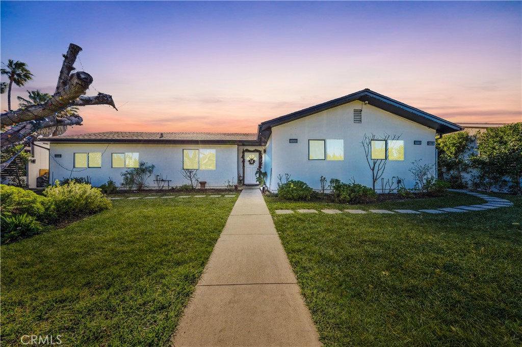 20200 Lassen Street Chatsworth, CA 91311 - Photo 4 of 32 a front view of a house with a yard