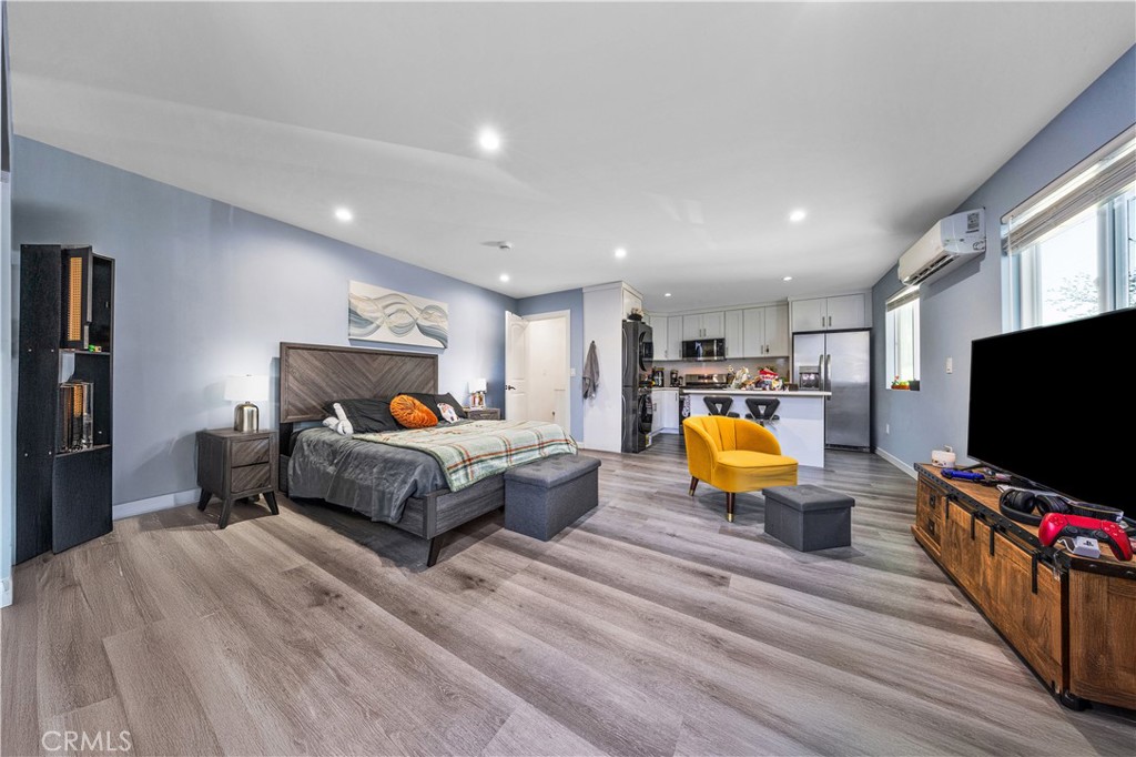 20200 Lassen Street Chatsworth, CA 91311 - Photo 6 of 32 a bedroom with furniture and a flat screen tv