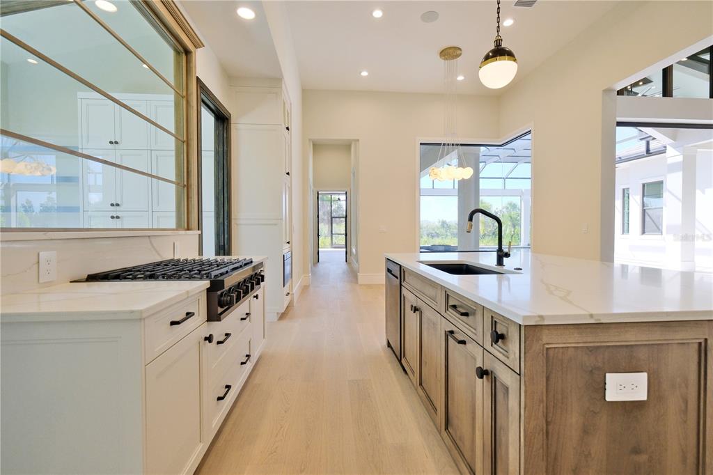 14758 Como Circle Lakewood Ranch, FL 34202 - Photo 18 of 85 a kitchen with stainless steel appliances a sink stove and cabinets