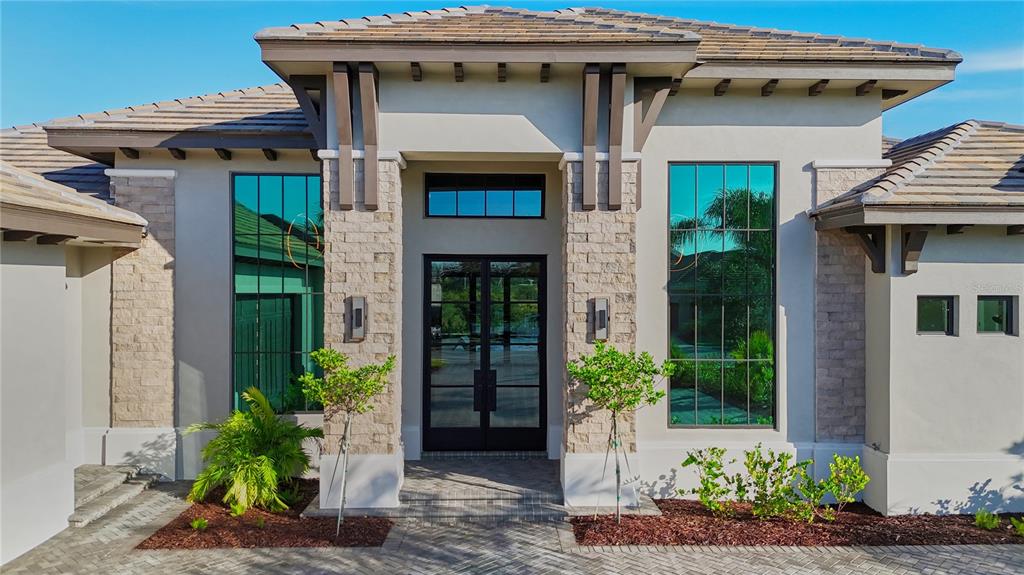 14758 Como Circle Lakewood Ranch, FL 34202 - Photo 3 of 85 a front view of a house with plants