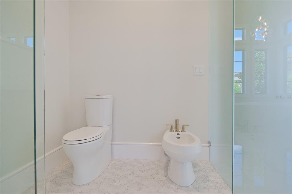 14758 Como Circle Lakewood Ranch, FL 34202 - Photo 40 of 85 a white toilet sitting next to a bathroom sink