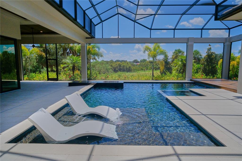 14758 Como Circle Lakewood Ranch, FL 34202 - Photo 61 of 85 a view of a patio with table and chairs under an umbrella