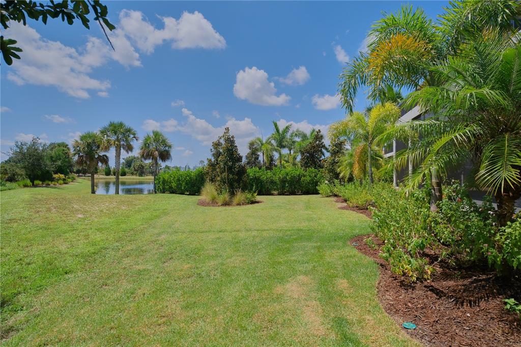 14758 Como Circle Lakewood Ranch, FL 34202 - Photo 70 of 85 a view of a garden with a building in the background