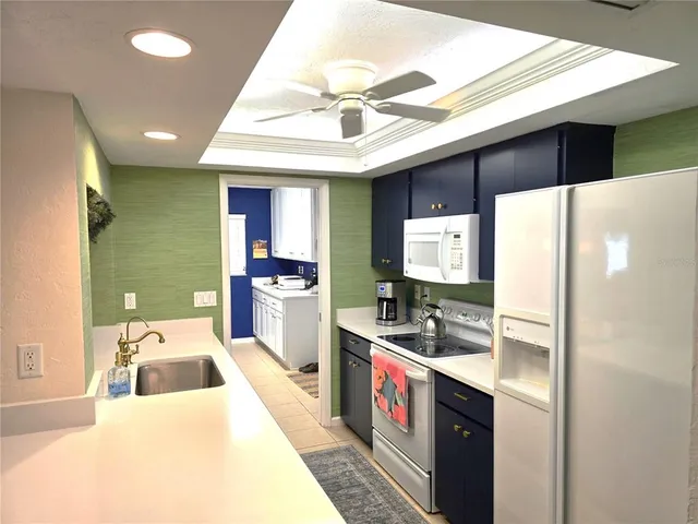 a kitchen with kitchen island a sink stainless steel appliances and cabinets