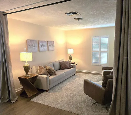 a living room with furniture and a window