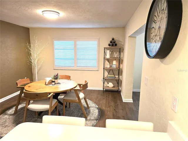 a living room with a table and chairs