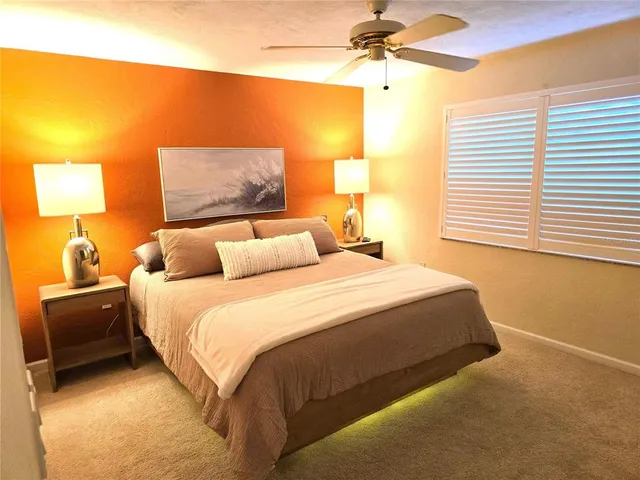 a bedroom with a bed and a lamp