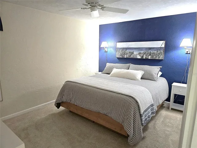 a bedroom with a bed and a lamp