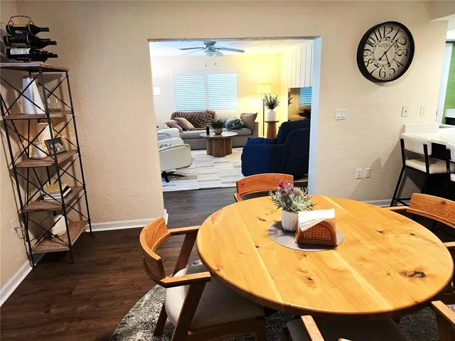 a view of a dining room with furniture and wooden floor