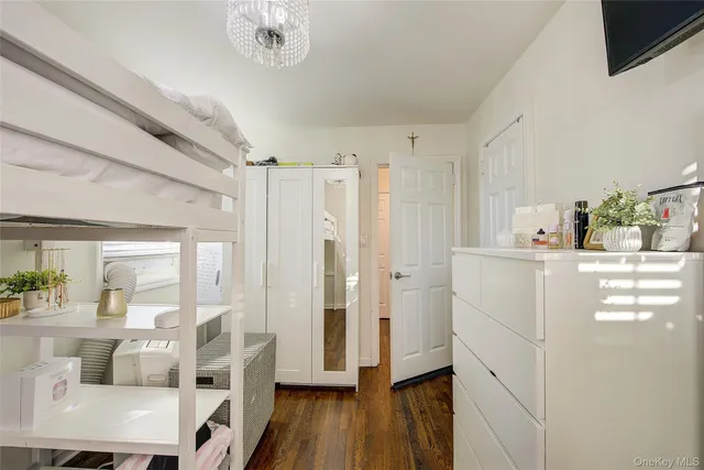 a kitchen with kitchen island white cabinets and stainless steel appliances
