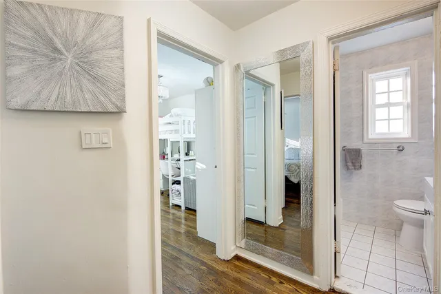 a bathroom with a glass shower door and a mirror