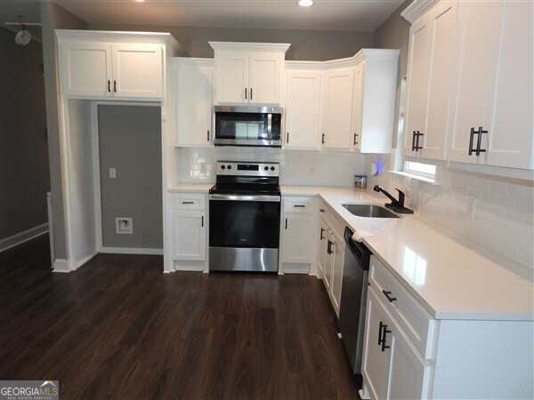 5915 Rye Patch Road Ludowici, GA 31316 - Photo 5 of 25 a kitchen with stainless steel appliances a sink dishwasher stove and refrigerator