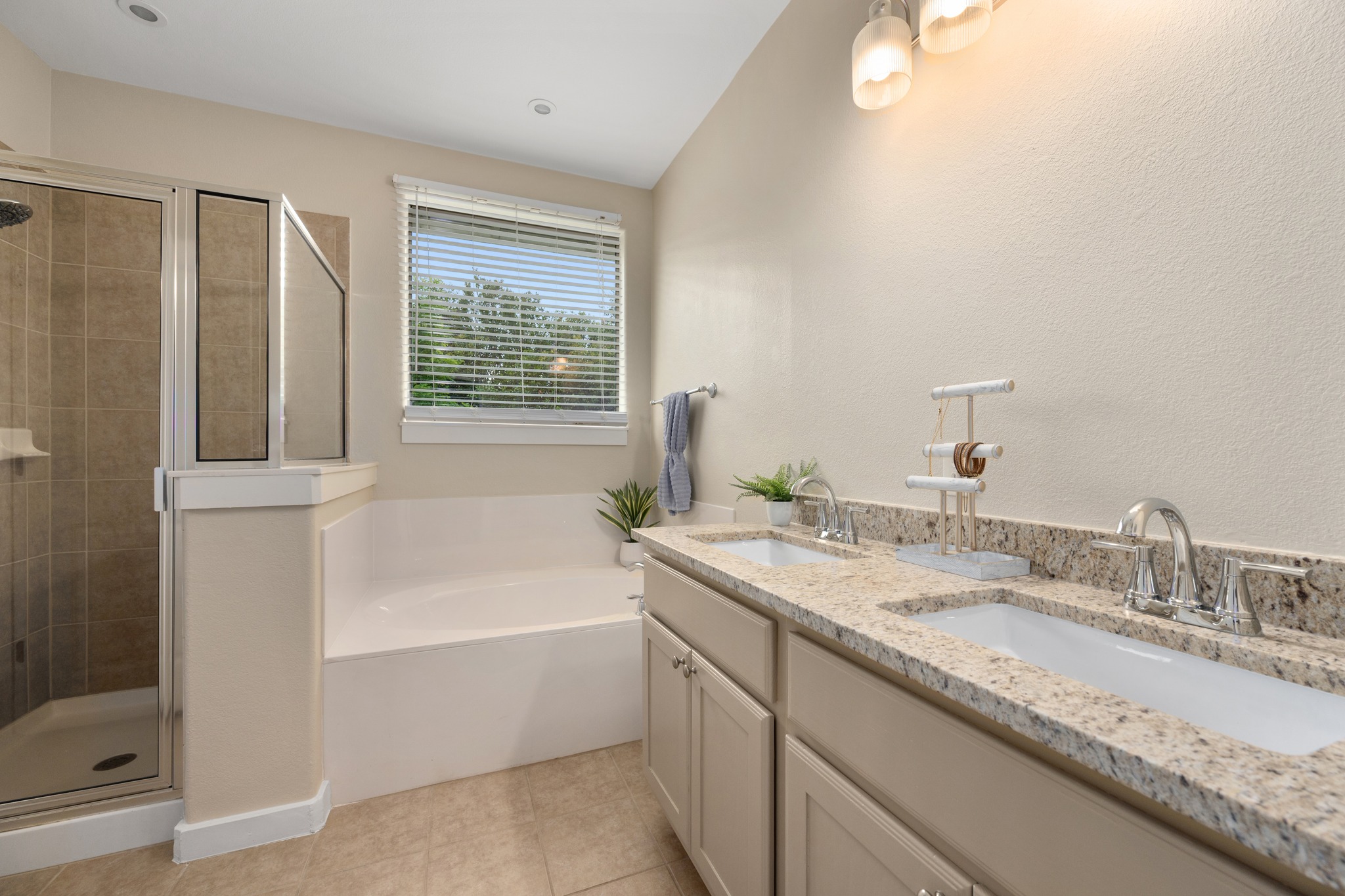 105 Rosebud Lane Georgetown, TX 78633 - Photo 12 of 37 a bathroom with a granite countertop sink and a bathtub