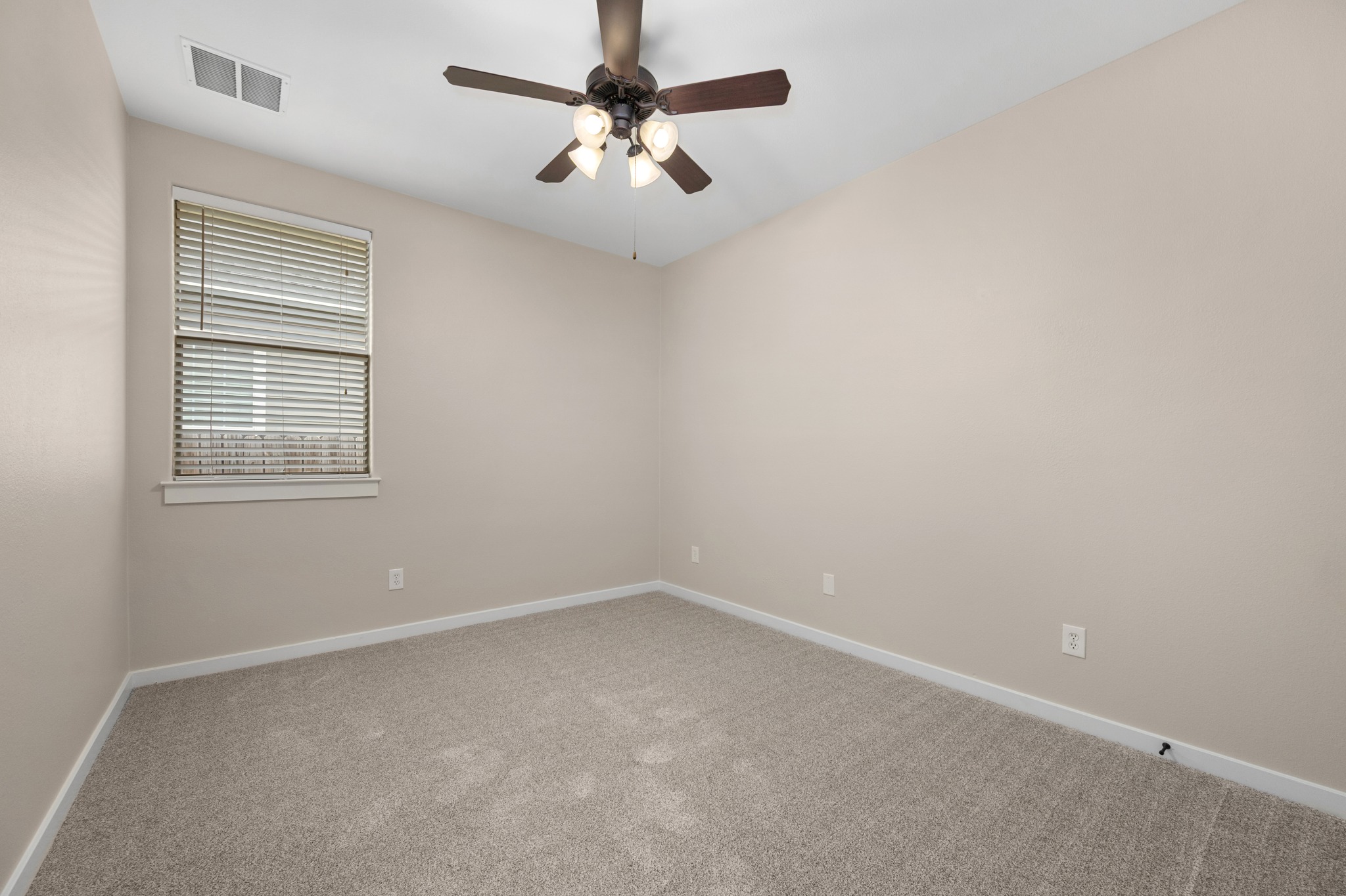 105 Rosebud Lane Georgetown, TX 78633 - Photo 14 of 37 an empty room with a window and a fan