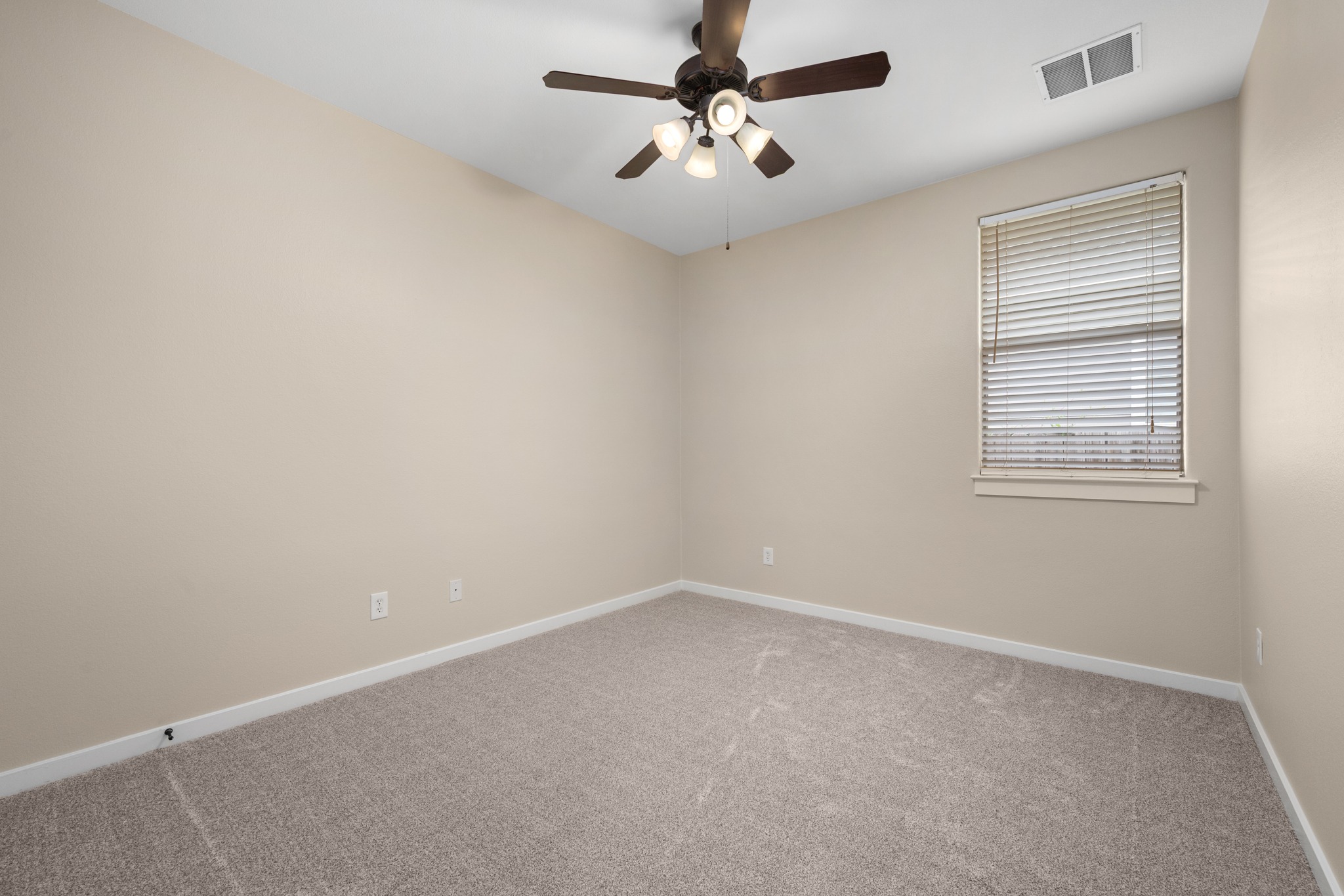 105 Rosebud Lane Georgetown, TX 78633 - Photo 15 of 37 an empty room with windows and fan