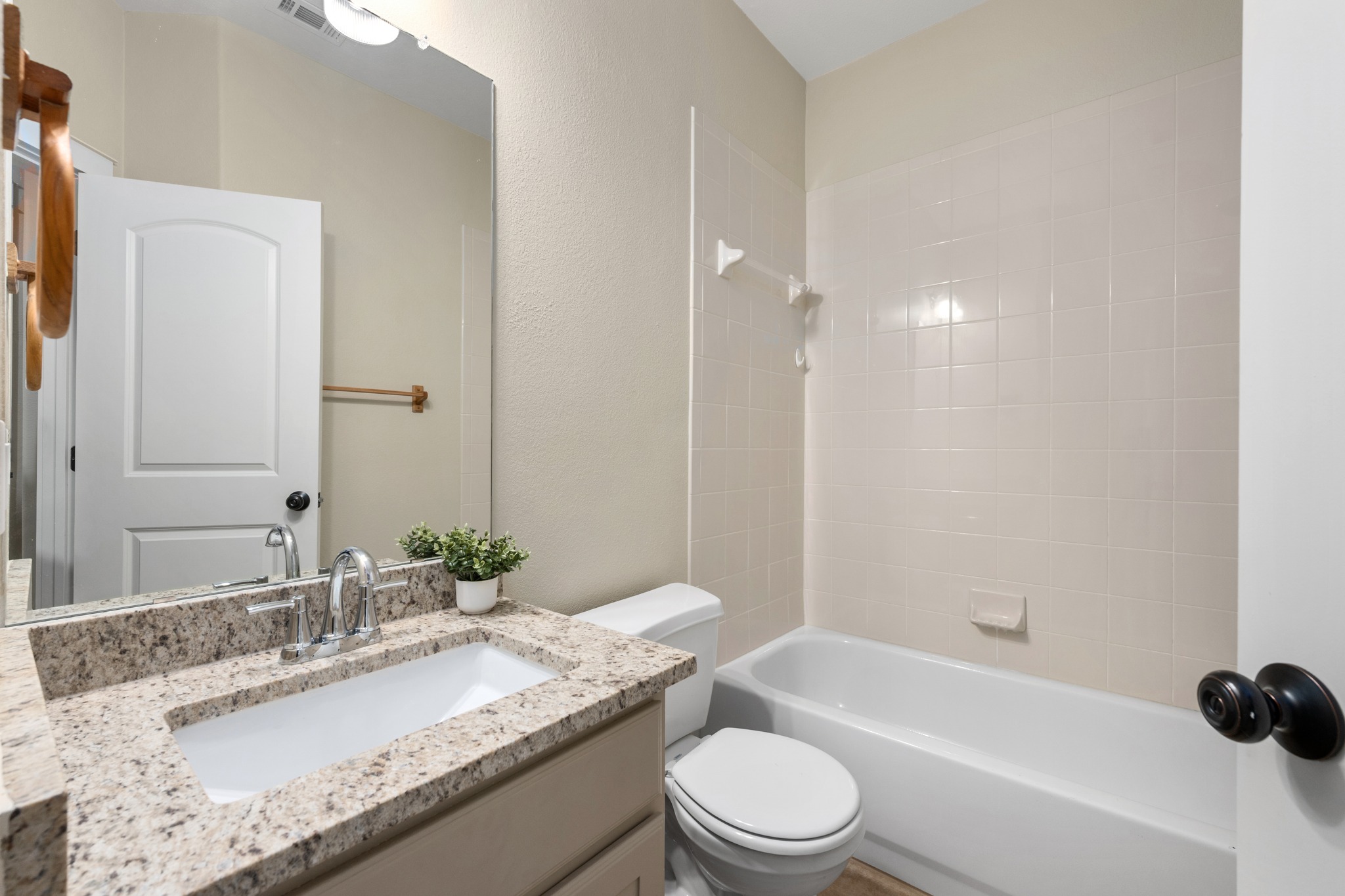105 Rosebud Lane Georgetown, TX 78633 - Photo 16 of 37 a bathroom with a granite countertop bathtub sink vanity mirror and toilet