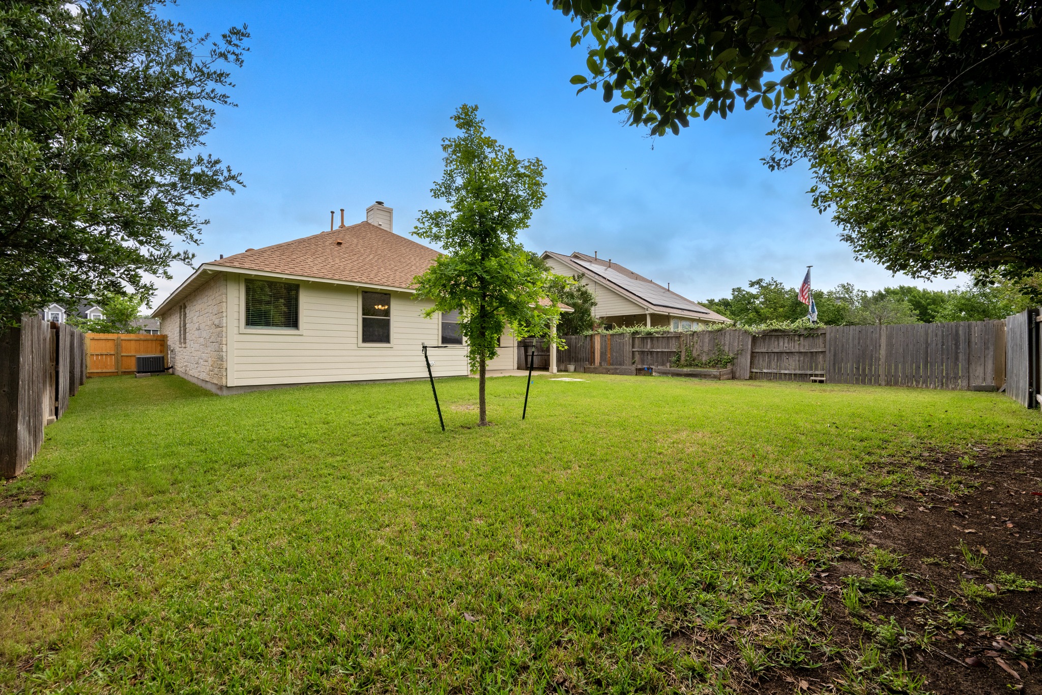 105 Rosebud Lane Georgetown, TX 78633 - Photo 20 of 37 a view of a house with backyard and a tree