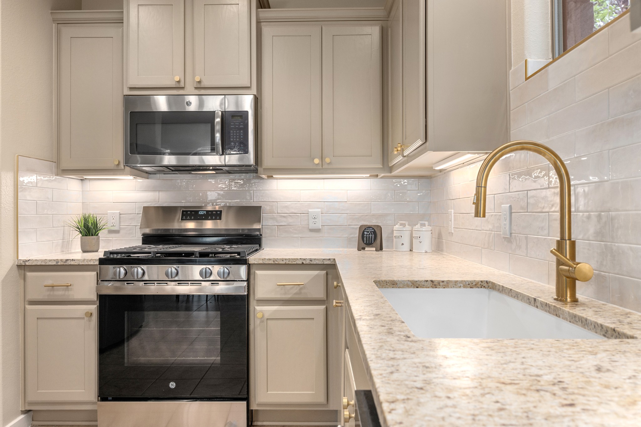 105 Rosebud Lane Georgetown, TX 78633 - Photo 3 of 37 a kitchen with stainless steel appliances granite countertop a stove a microwave and a sink