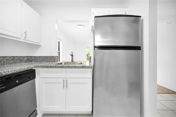 a kitchen with a refrigerator and cabinets