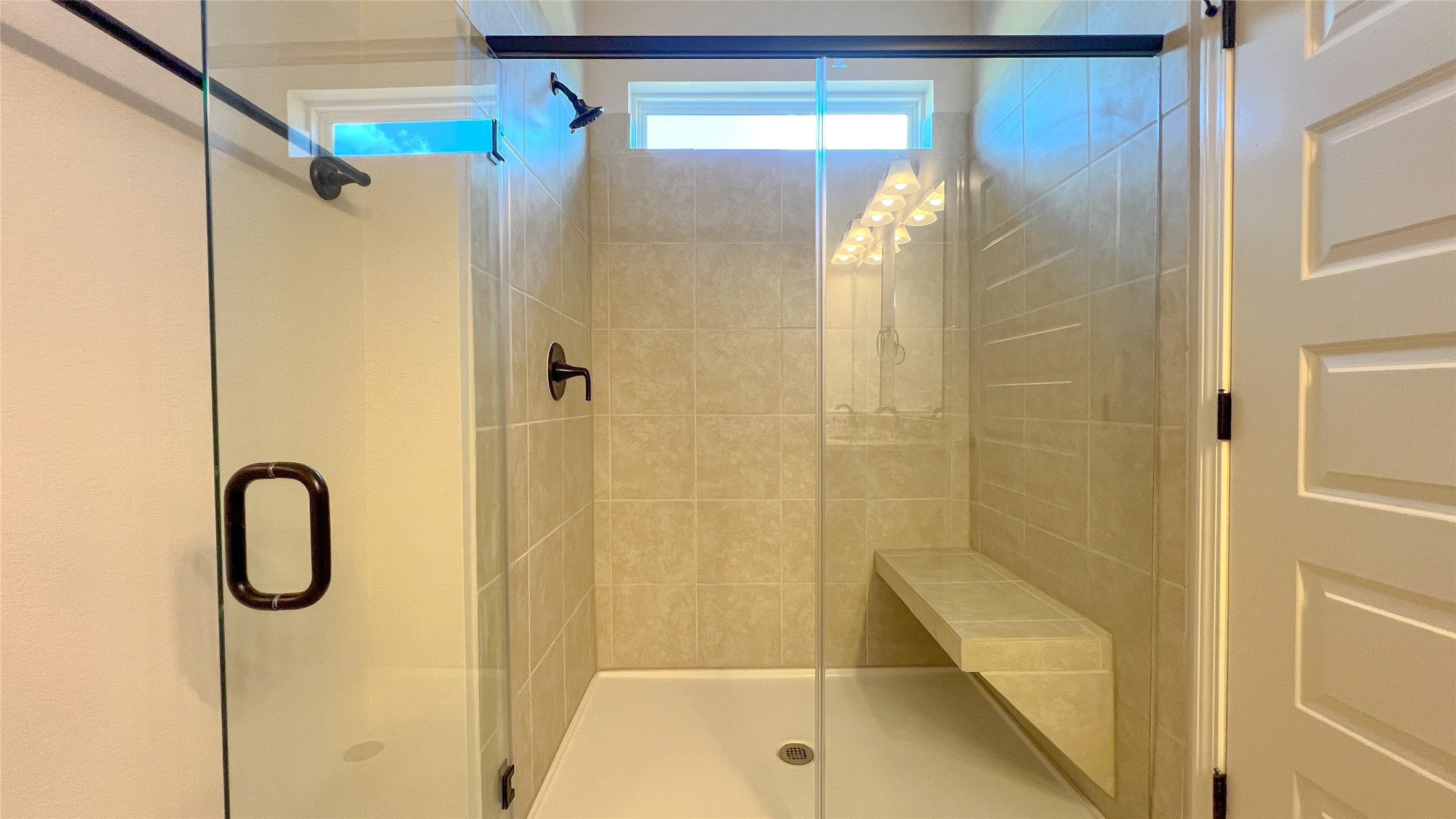 9793 Enclave Ridge Road Willis, TX 77318 - Photo 10 of 17 The Blue Jay II- Primary Bathroom with Large Walk-in Shower with Bench Seat