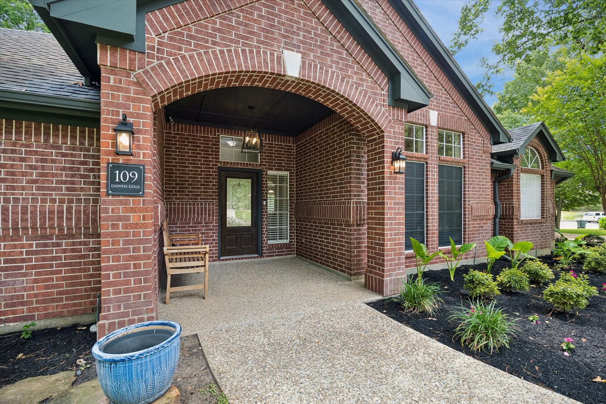 109 Dawns Edge Conroe, TX 77356 - Photo 2 of 24 a front view of a house with potted plants