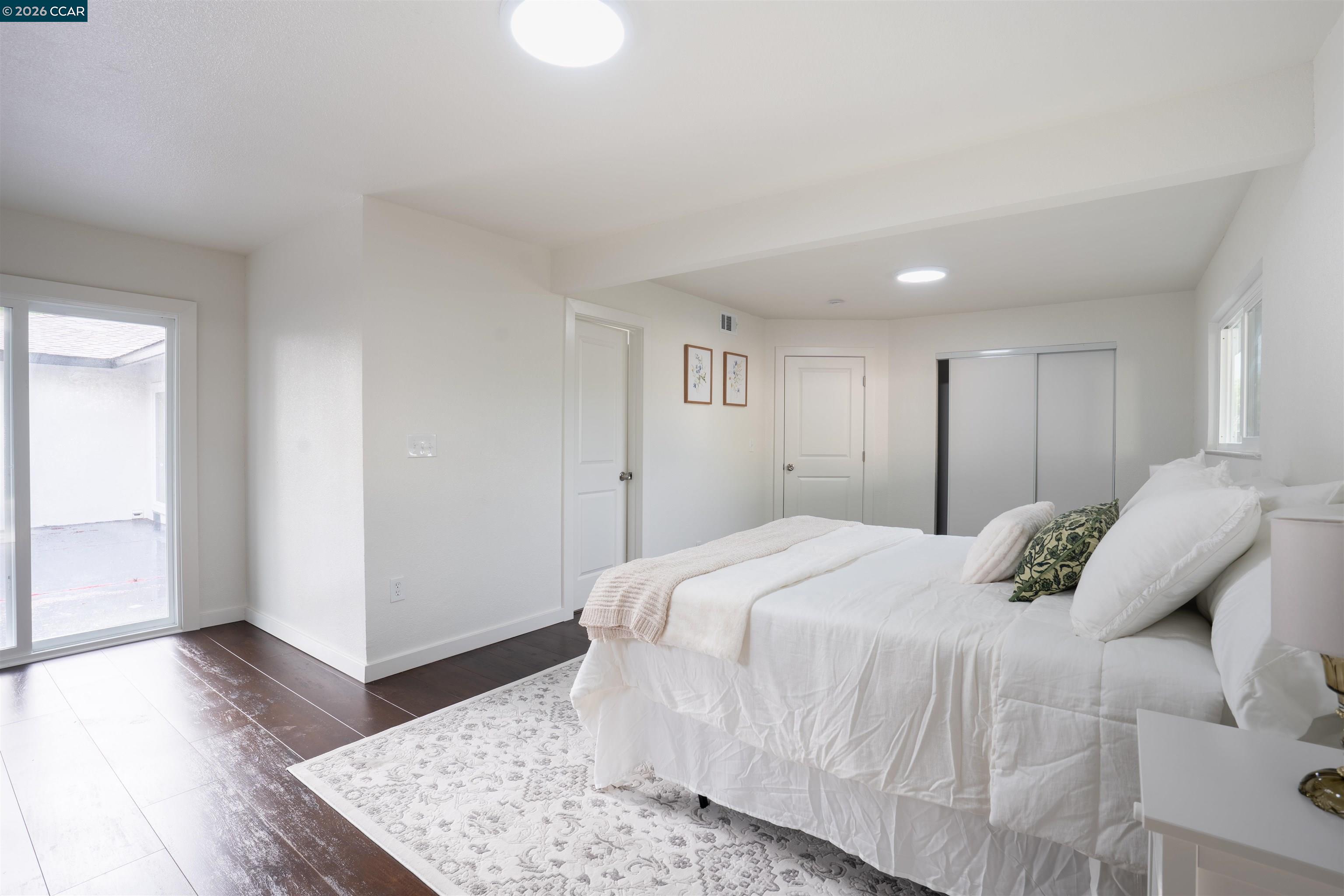 58 Solano Avenue Bay Point, CA 94565 - Photo 12 of 23 a bedroom with a bed and wooden floor