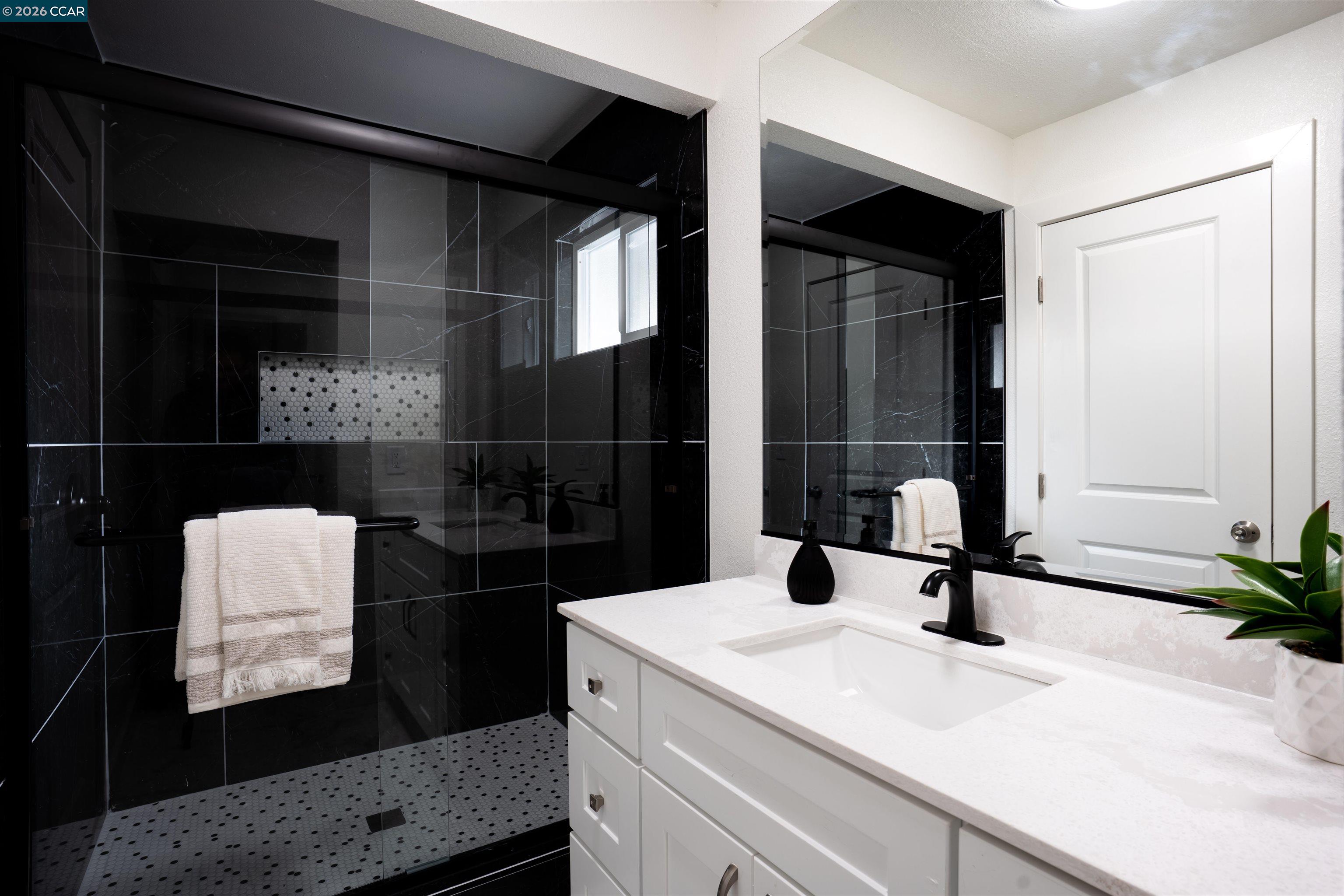 58 Solano Avenue Bay Point, CA 94565 - Photo 15 of 23 a bathroom with a sink and a mirror