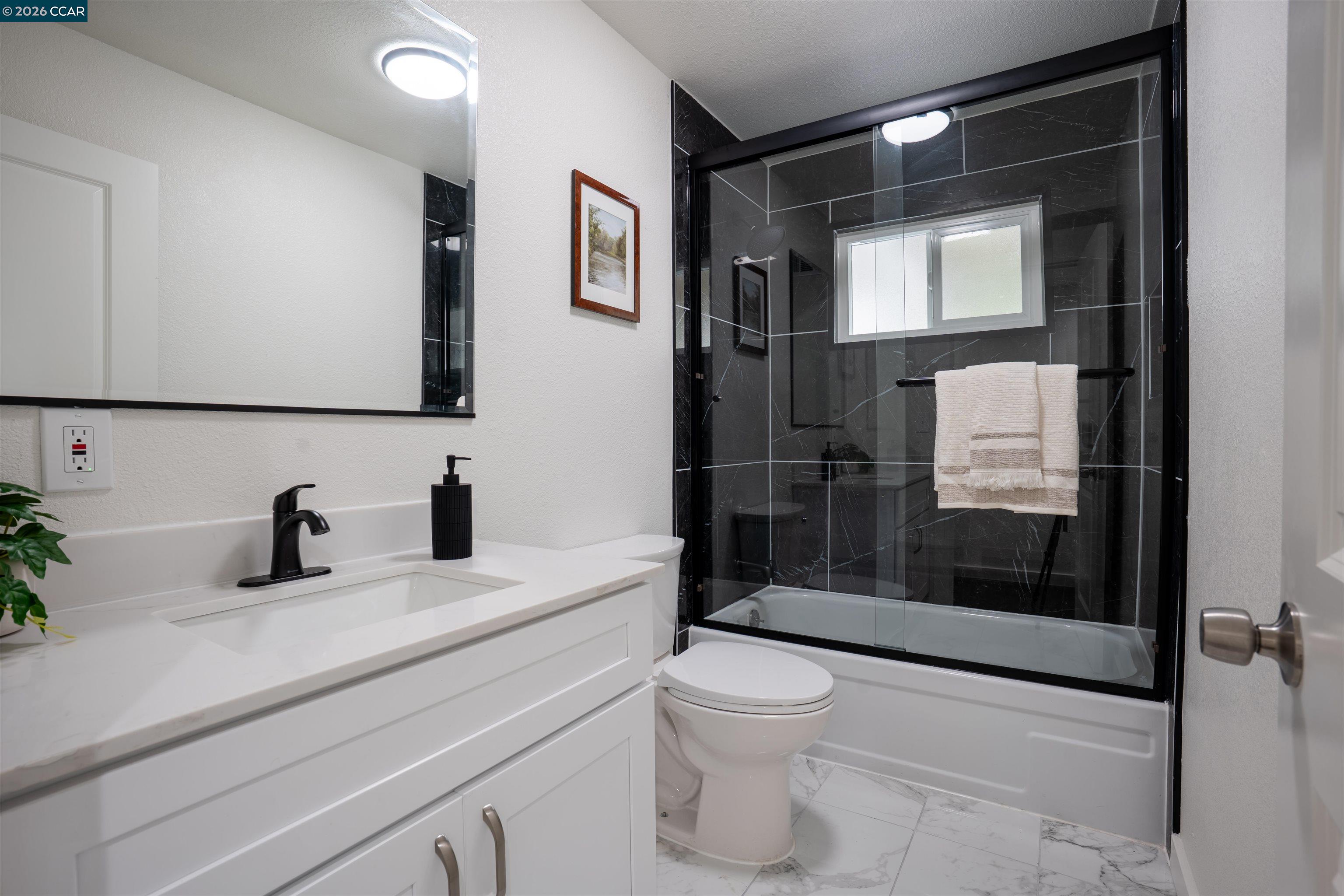 58 Solano Avenue Bay Point, CA 94565 - Photo 7 of 23 a bathroom with a sink a toilet and shower