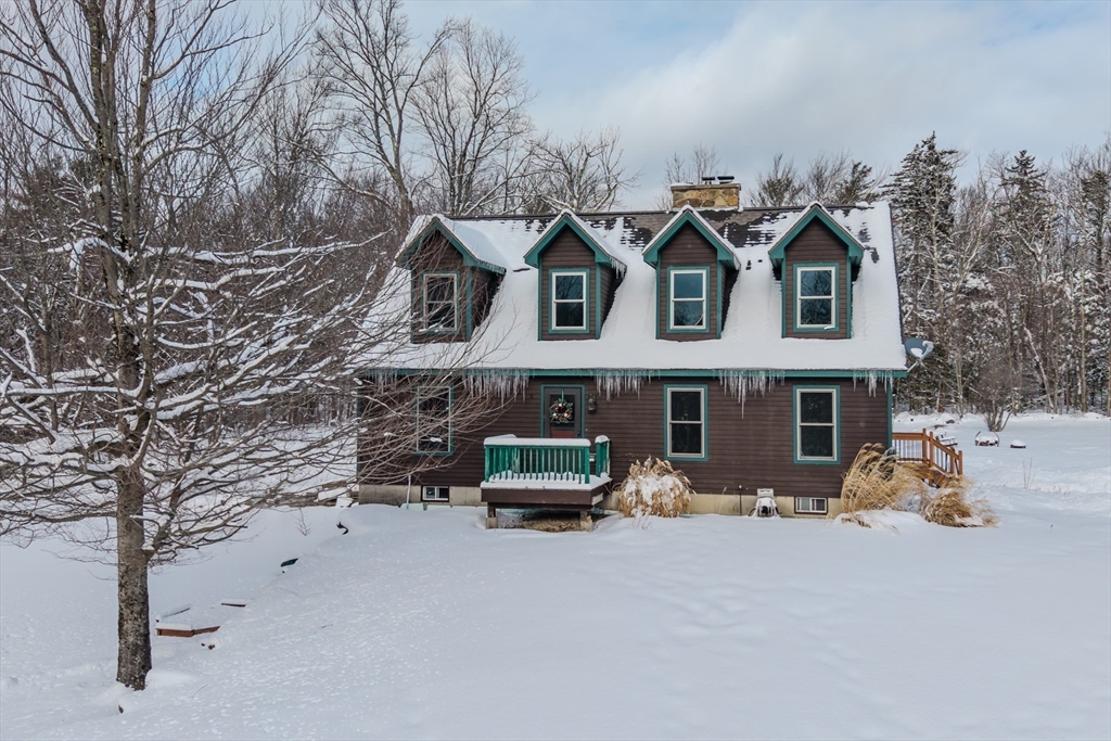 a front view of a house with car parked