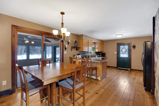 a dining room with furniture and wooden floor