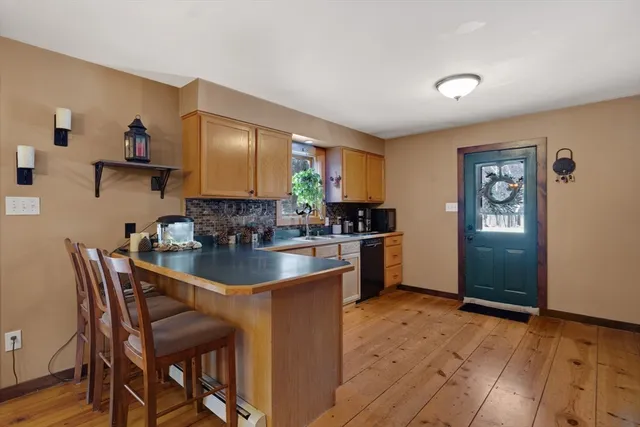 a kitchen with a table chairs refrigerator and cabinets