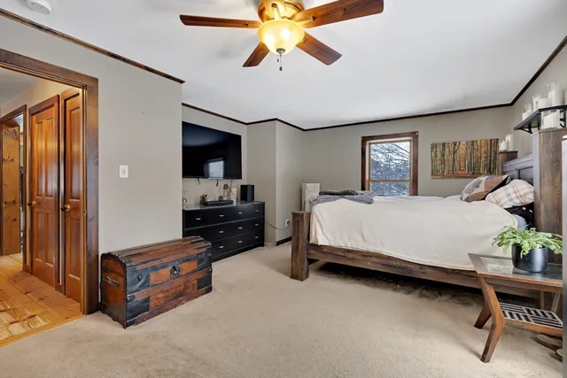 a bedroom with a bed and a chandelier