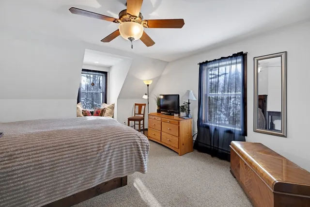 a bedroom with a large bed a flat screen tv and couches