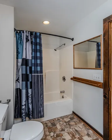 a bathroom with a toilet and shower