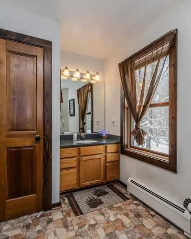 a room with a large mirror and a sink