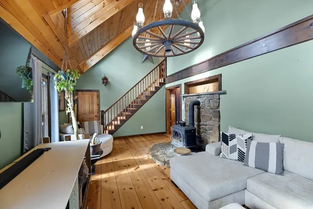 a view of a livingroom with furniture staircase and a chandelier