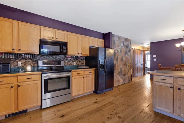 a kitchen with stainless steel appliances granite countertop a refrigerator stove and sink