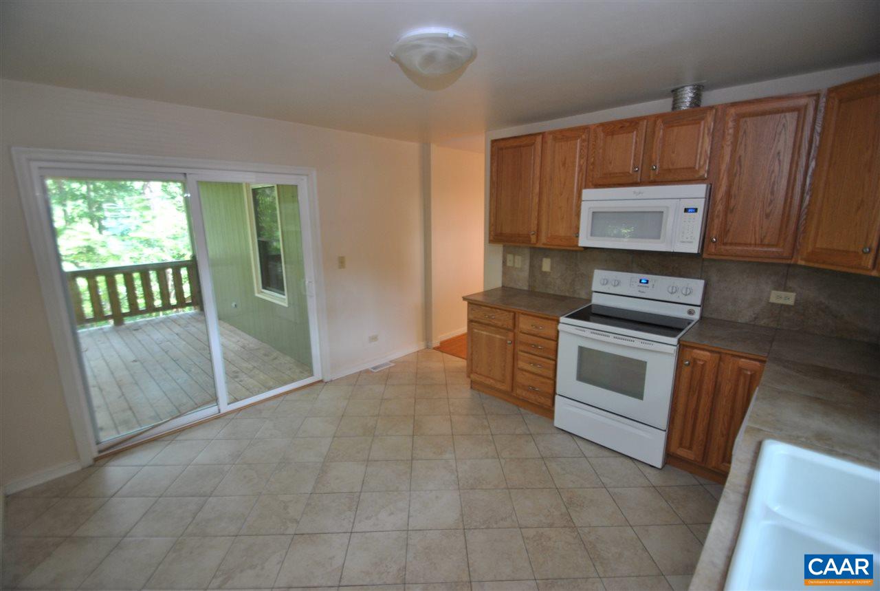 114 Elkhorn Road Charlottesville, VA 22903 - Photo 11 of 23 a kitchen with granite countertop a stove top oven microwave and cabinets