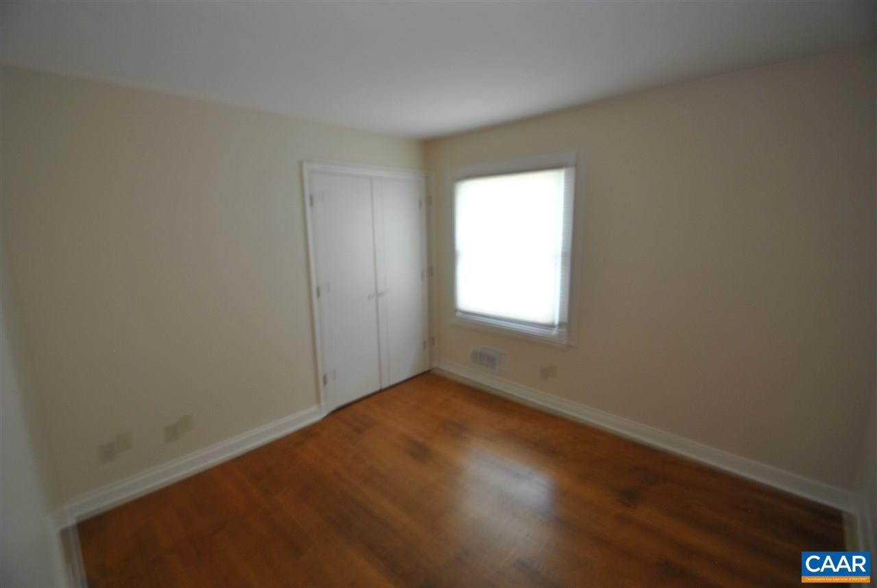 114 Elkhorn Road Charlottesville, VA 22903 - Photo 14 of 23 an empty room with wooden floor and windows