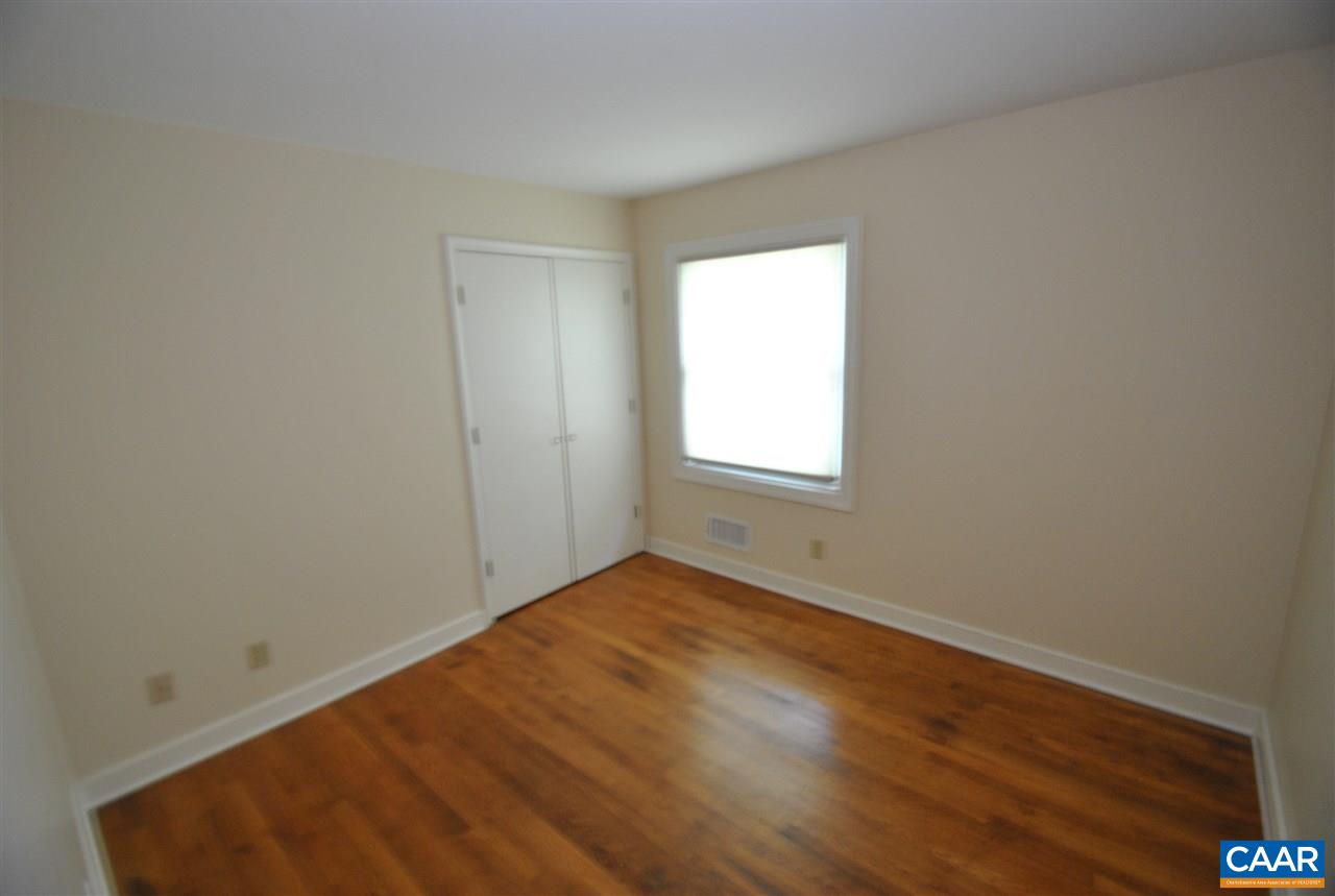114 Elkhorn Road Charlottesville, VA 22903 - Photo 15 of 23 an empty room with wooden floor and windows