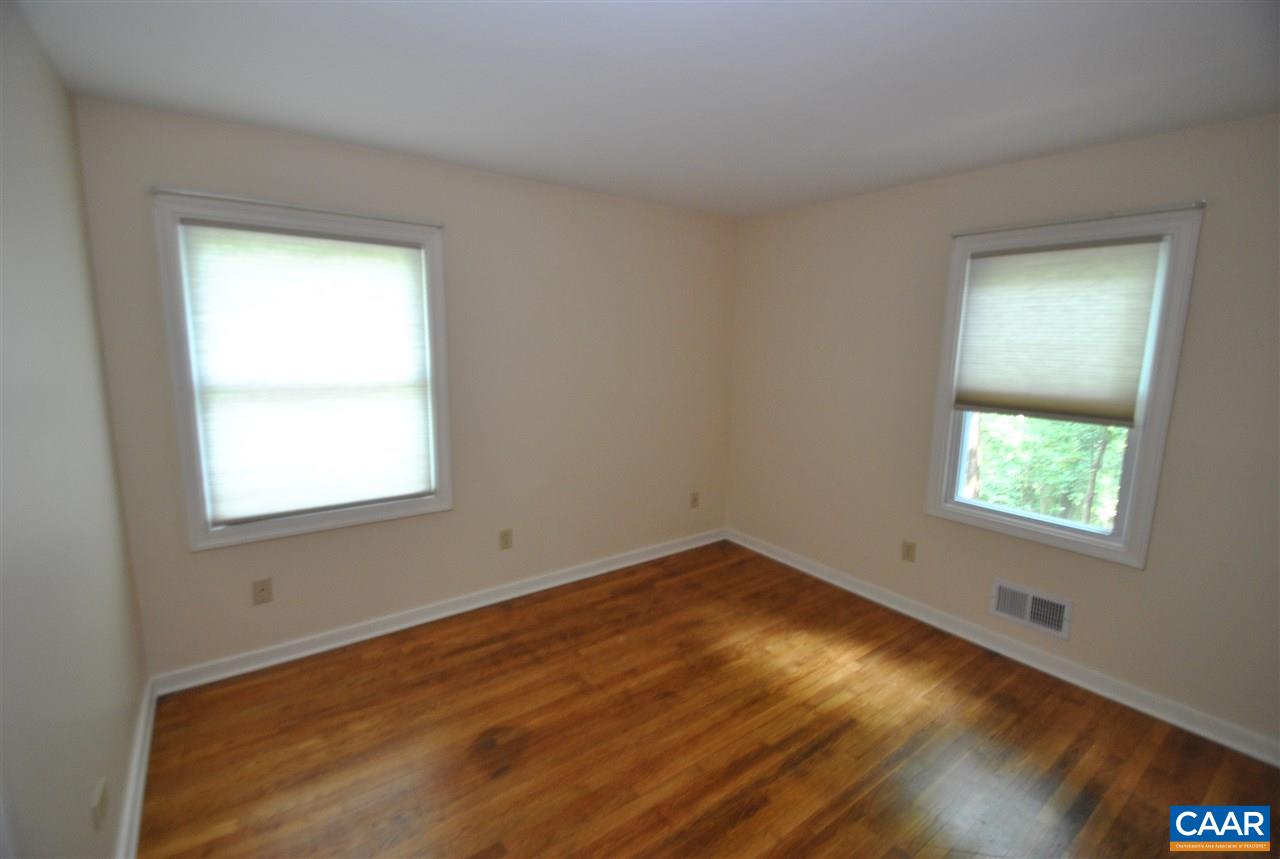 114 Elkhorn Road Charlottesville, VA 22903 - Photo 17 of 23 a view of an empty room with wooden floor and a window